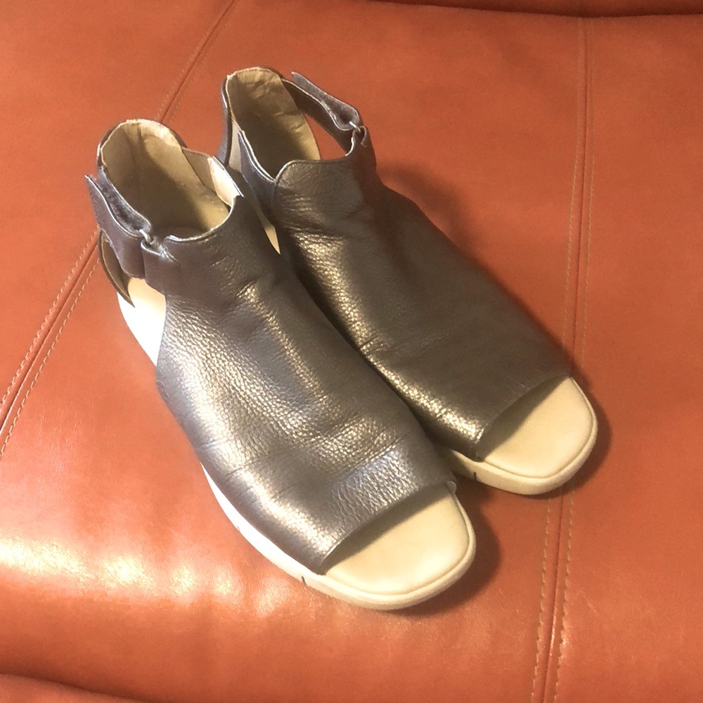 The Flexx peek-a-boo toe sandals are supportive. Silver with. A white sole.